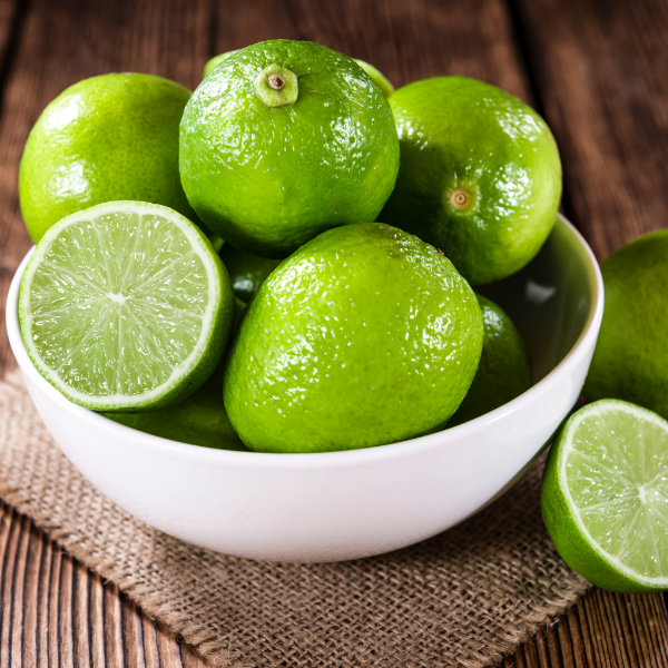 Seedless limes in a 1 kg pack from Local Market, fresh and vibrant green fruit on a wooden surface.