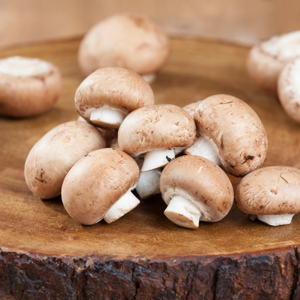 Fresh chestnut mushrooms from Sharbatly, 0.25kg pack, showing whole mushrooms with brown caps and stems on a white background.
