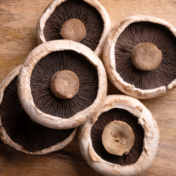 Fresh Holland Portobello mushrooms in a 0.2 kg vegetable pack, showing large, brown caps and sturdy stems.