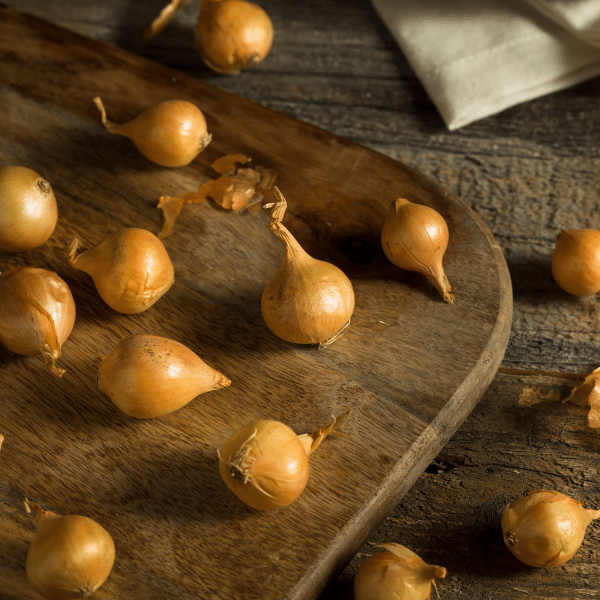 Golden pearl onion from Holland, baby-sized vegetable in 0.5 kg pack, fresh and round with smooth golden skin.