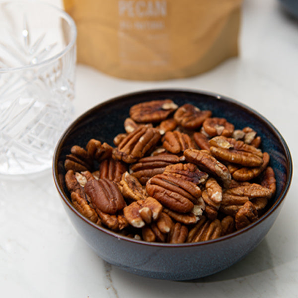 All-natural pecans in a 0.25 kg pack from Fresh Nuts, showing whole, roasted pecan nuts on a neutral background.