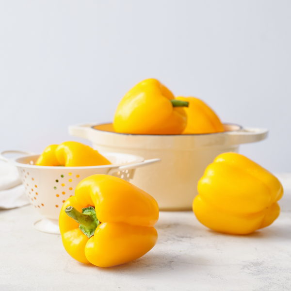 Yellow capsicum peppers from Local Market, fresh vegetable in a 1 kg pack, vibrant and crisp for cooking or salads.
