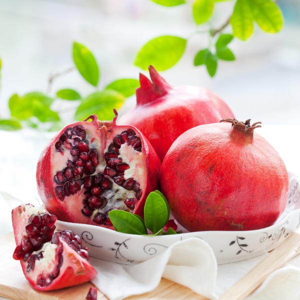 Fresh pomegranates from Local Market in a 2 kg carton, showcasing bright red, ripe fruit ready to enjoy.