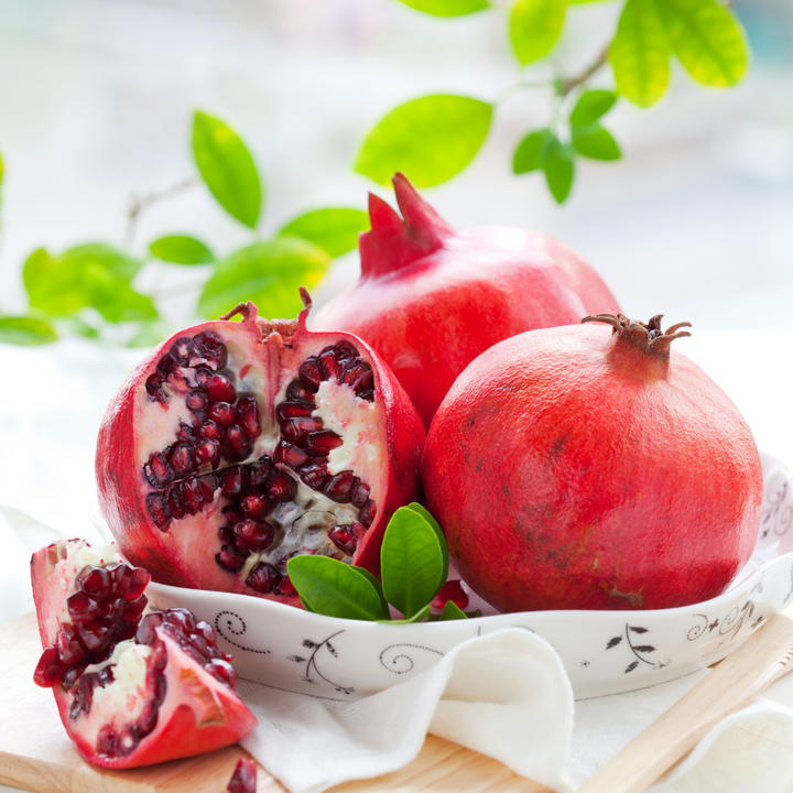 Fresh red pomegranates from Sharbatly, 2 kg carton of whole fruit with vibrant, seeded exterior.