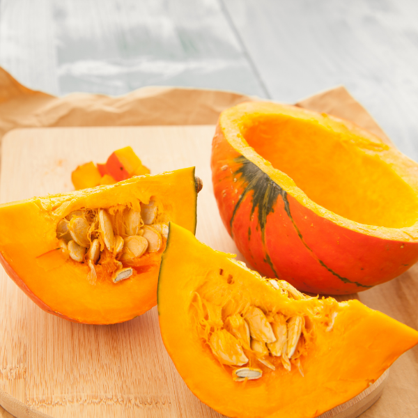 Holland Hokkaido pumpkin, red Kuri squash vegetable, single orange pumpkin with smooth skin and rounded shape.