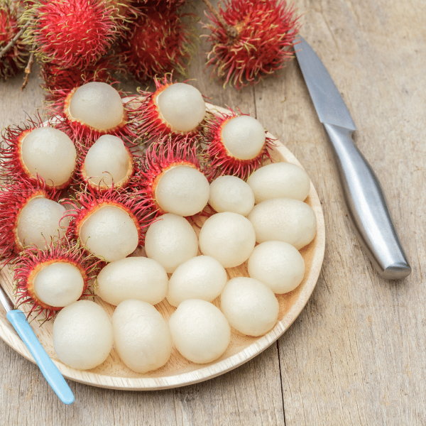 Fresh Thailand rambutan fruit in a 0.5 kg pack with hairy red and green shell, ready to eat.