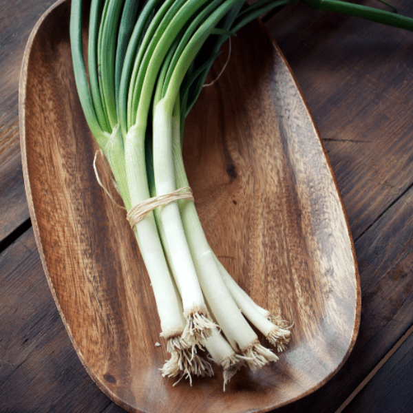 Fresh spring onions bunch from Local Market, vibrant green stems and white bulbs, ideal for cooking and garnishing.