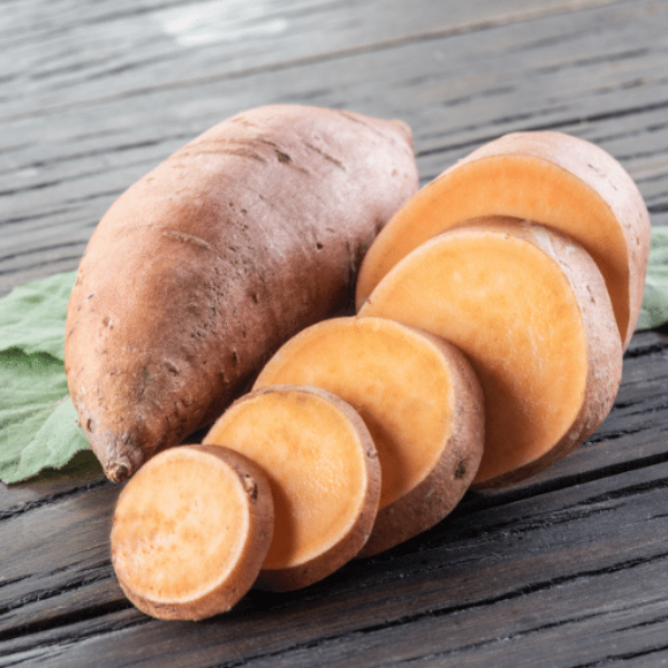 Fresh sweet potatoes from Local Market, 3 kg carton, showing vibrant orange skin and rustic roots in a natural setting.