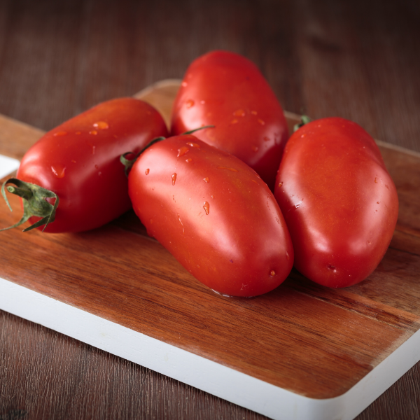 Holland 1 kg pack of fresh San Marzano and Roma tomatoes, vibrant red vegetables ideal for cooking or salads.