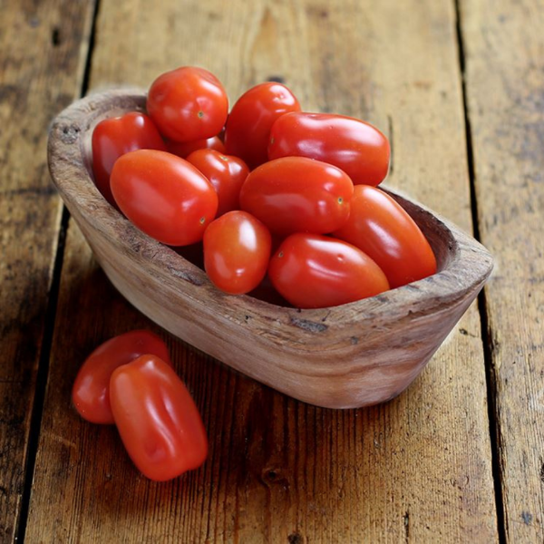 Fresh cherry plum tomatoes in a 0.25 kg pack by Sharbatly, showcasing vibrant red, round vegetables on a white background.