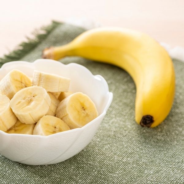 Fresh yellow bananas from Sharbatly in a 1 kg bunch, ripe and ready to eat, on a neutral background.