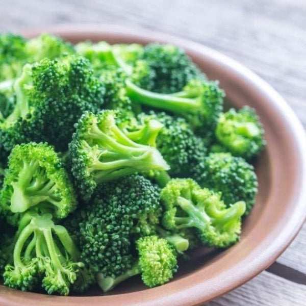 Fresh green broccoli heads in a Sharbatly vegetable pack, showcasing vibrant, healthy produce ready for cooking or snacking.