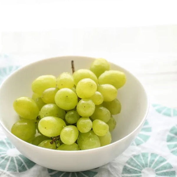 White seedless cotton candy grapes from Sharbatly, fresh and plump in a 4.5 kg carton, showcasing their translucent, juicy appearance.