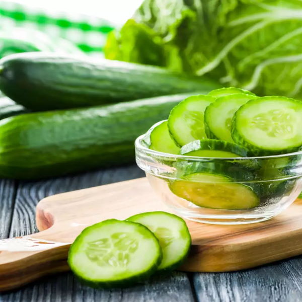 Fresh green cucumbers from Local Market, 1 kg pack, showing smooth skin and crisp texture on a white background.