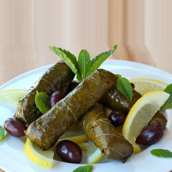Fresh green grape leaves in a 0.5 kg box from Local Market, vegetable product for cooking or stuffing.