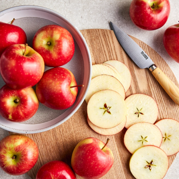 Fresh Kanzi apples in a 1 kg pack from Sharbatly, showcasing shiny, red and yellow fruit ready to enjoy.