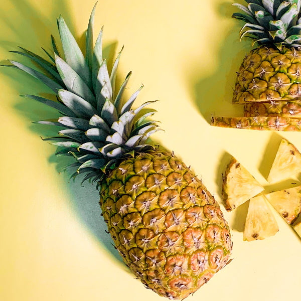 Fresh pineapple honey extra fruit from Local Market, single piece with vibrant yellow color and textured exterior.