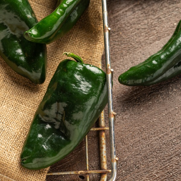 Fresh green Holland Poblano peppers in a 0.350 kg pack, showcasing vibrant, smooth, and flavorful herb peppers.