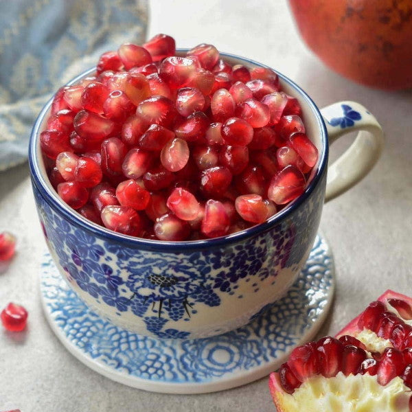 Fresh pomegranates from Sharbatly in a 3.8 kg carton, showcasing vibrant red fruit with smooth, round skins.