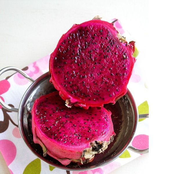 Fresh purple flesh dragon fruit, also known as red pitaya, from Thailand, displayed as a single vibrant fruit.