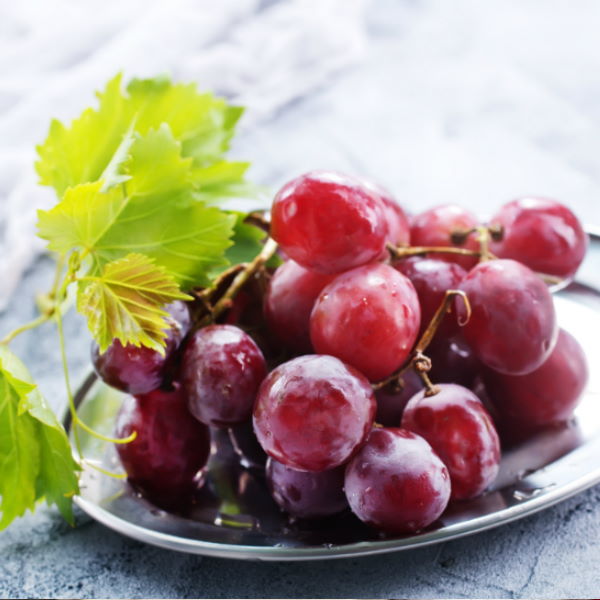 Red Globe grapes in a 1 kg pack from Sharbatly, fresh red fruit with large, plump berries on the vine.