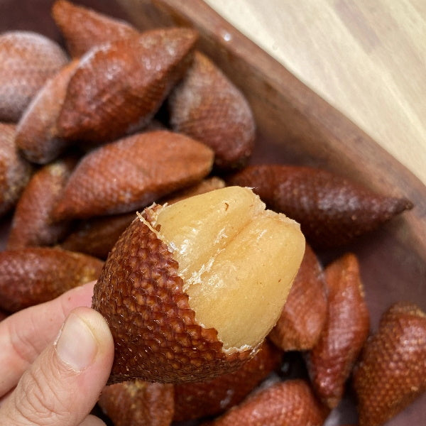 Fresh snake fruit (salak) from Thailand, 0.5 kg pack, showing reddish-brown scaly skin and tropical fruit inside.