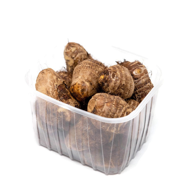 Fresh taro roots in a 1 kg pack, showcasing their rough brown skin and starchy white flesh, from Local Market vegetable selection.