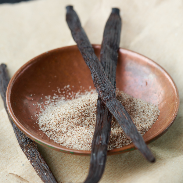 Holland vanilla pods, 5 pieces of fresh natural fruit with dark brown skins and aromatic scent on a white background.