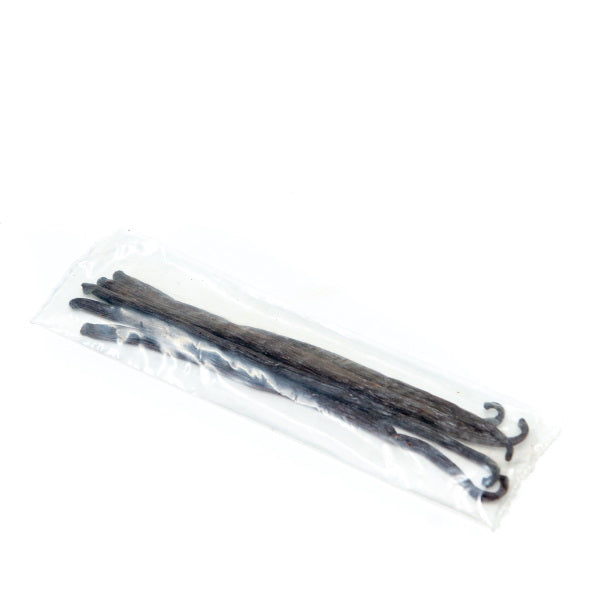 Five fresh vanilla pods from Holland, showcasing their dark, aromatic fruit pods on a natural background.