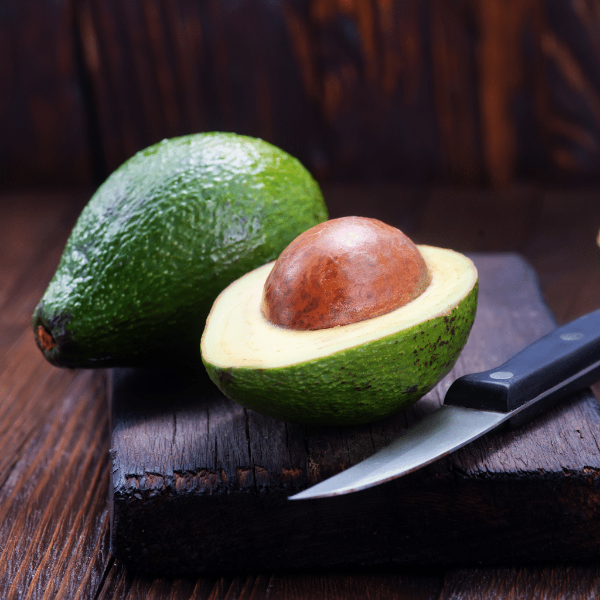 Fresh Fuerte avocados in a 1 kg punnet from Sharbatly, showcasing ripe green fruit on the website image.