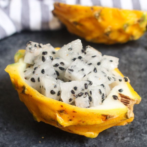 Single yellow dragon fruit (yellow pitaya) from Holland, showcasing vibrant yellow skin and fresh interior.